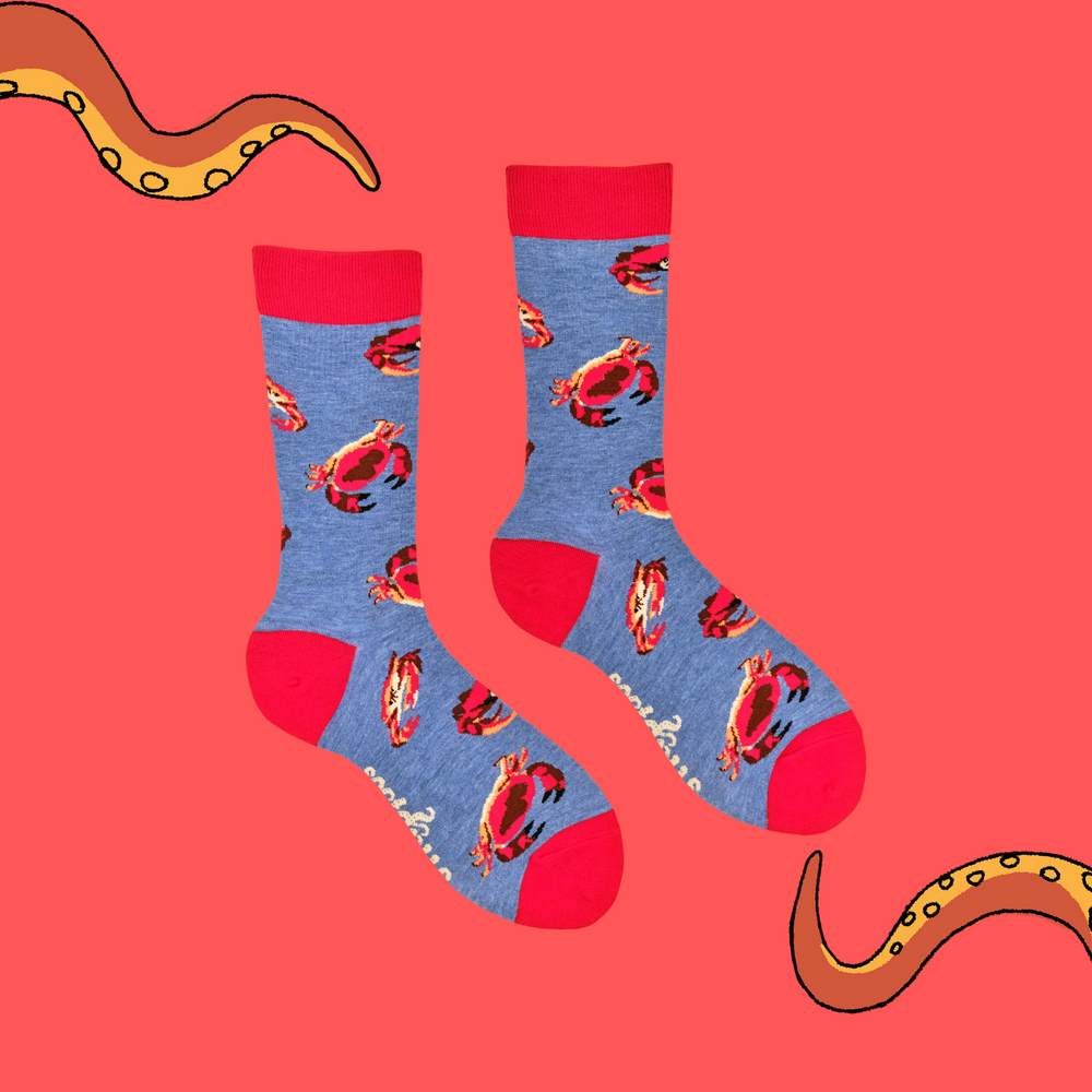 
                      
                        A pair of socks featuring a crab motif. Blue legs, red heel, toe and cuff. 
                      
                    