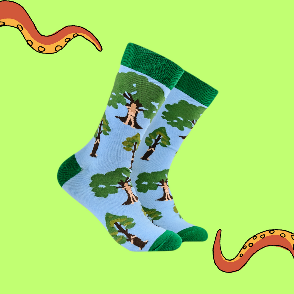 A pair of socks featuring tree huggers. Blue legs, green heel, toe and cuff. 