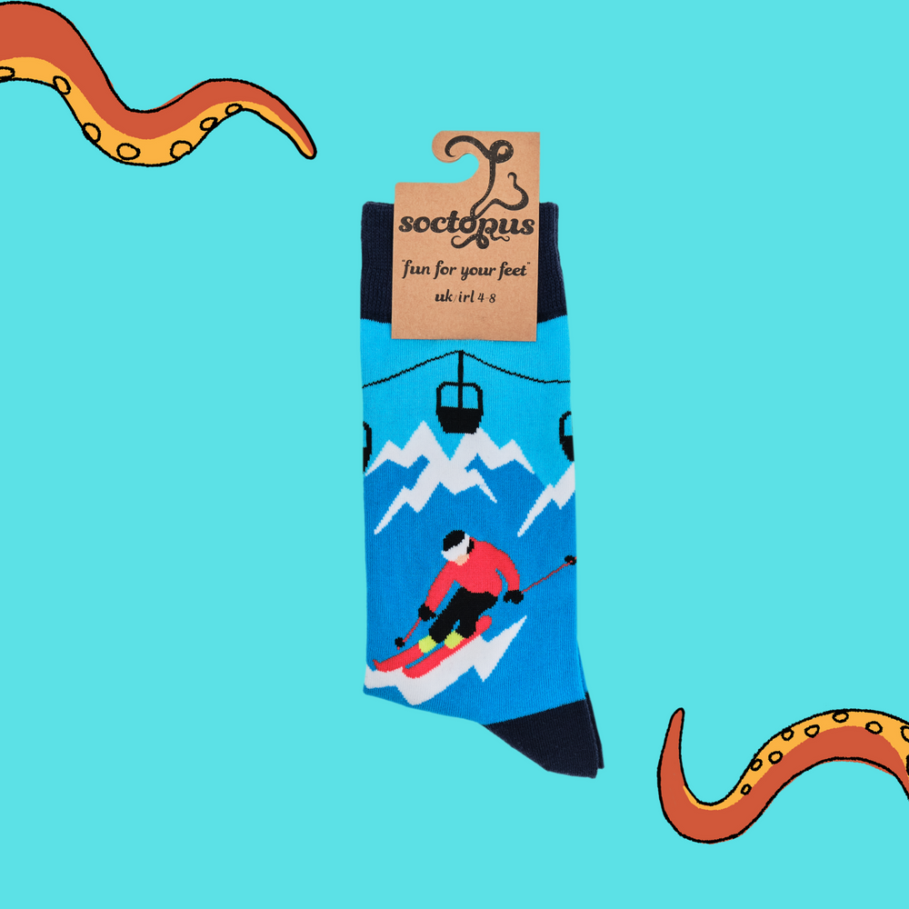 
                  
                    A pair of socks depicting skiers on the slopes. Blue legs, dark blue cuff, heel and toe. In Soctopus Packaging.
                  
                