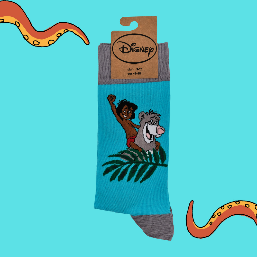 
                      
                        A pair of socks depicting Mowglie and Baloo playing in the jungle. Turquoise legs, grey toes, heel and cuff.
                      
                    