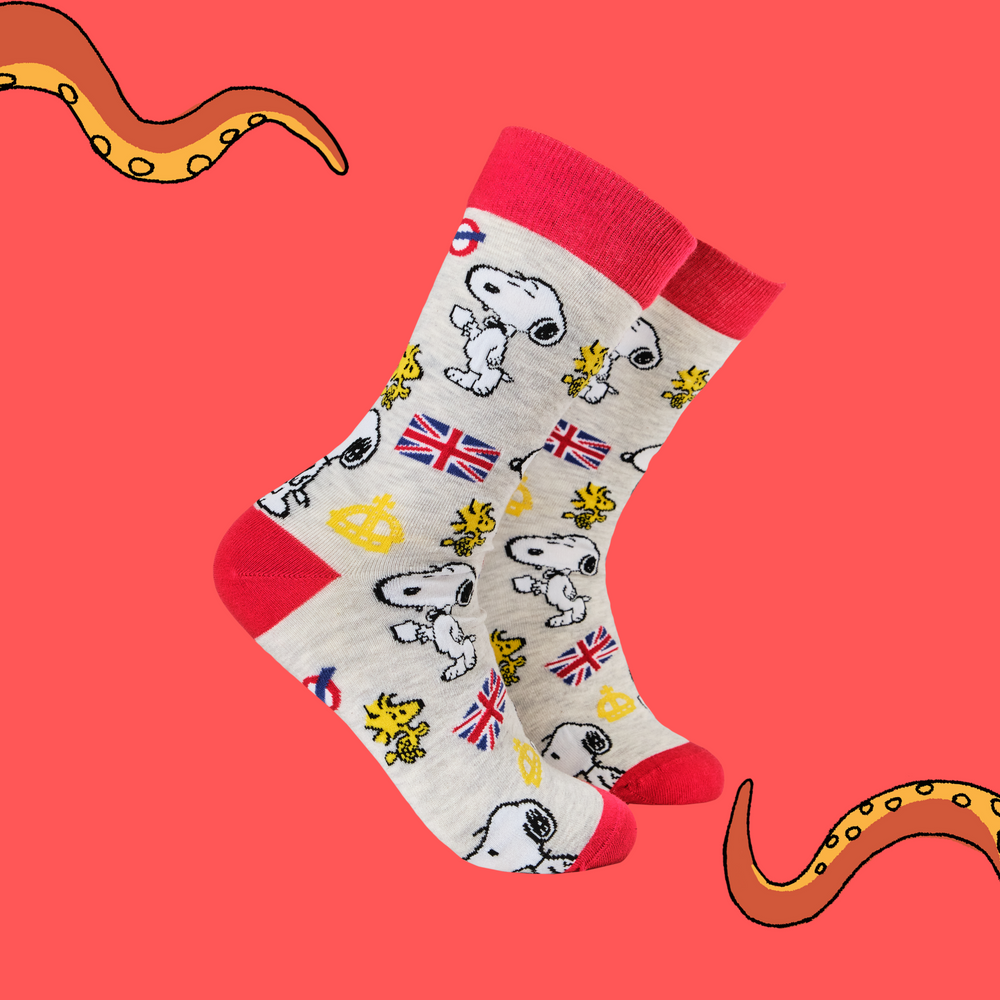 
                      
                         A pair of socks depicting Snoopy and Woodstock with a London motif. Grey legs, red cuff, toe and heel. 
                      
                    