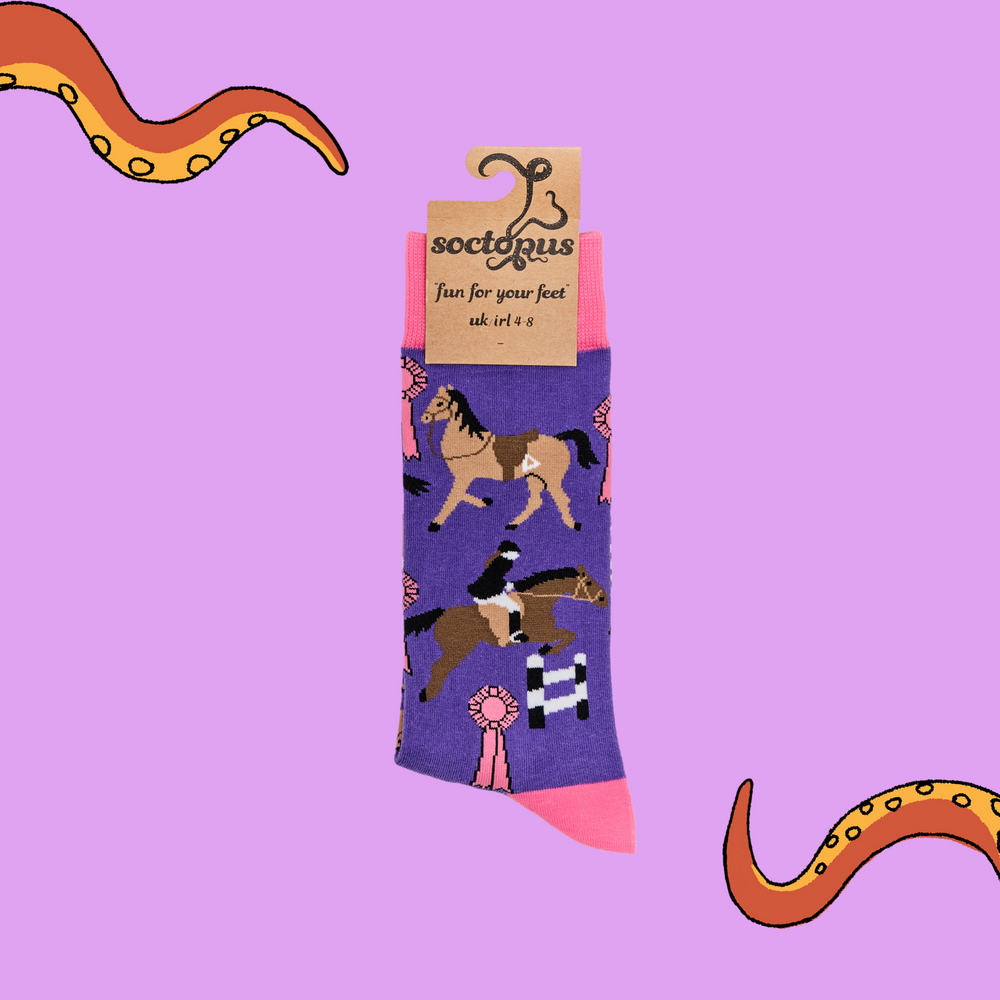 
                      
                        A pair of socks depicting tea cups and show jumping horses. Purple legs, pink cuff, heel and toe. In Soctopus Packaging.
                      
                    