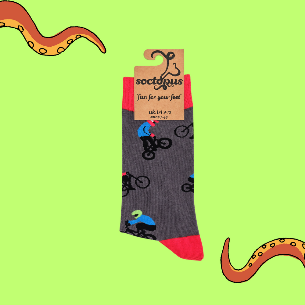 
                      
                        A pair of socks depicting people riding BMX bikes. Grey legs, red cuff, heel and toe. In Soctopus Packaging.
                      
                    