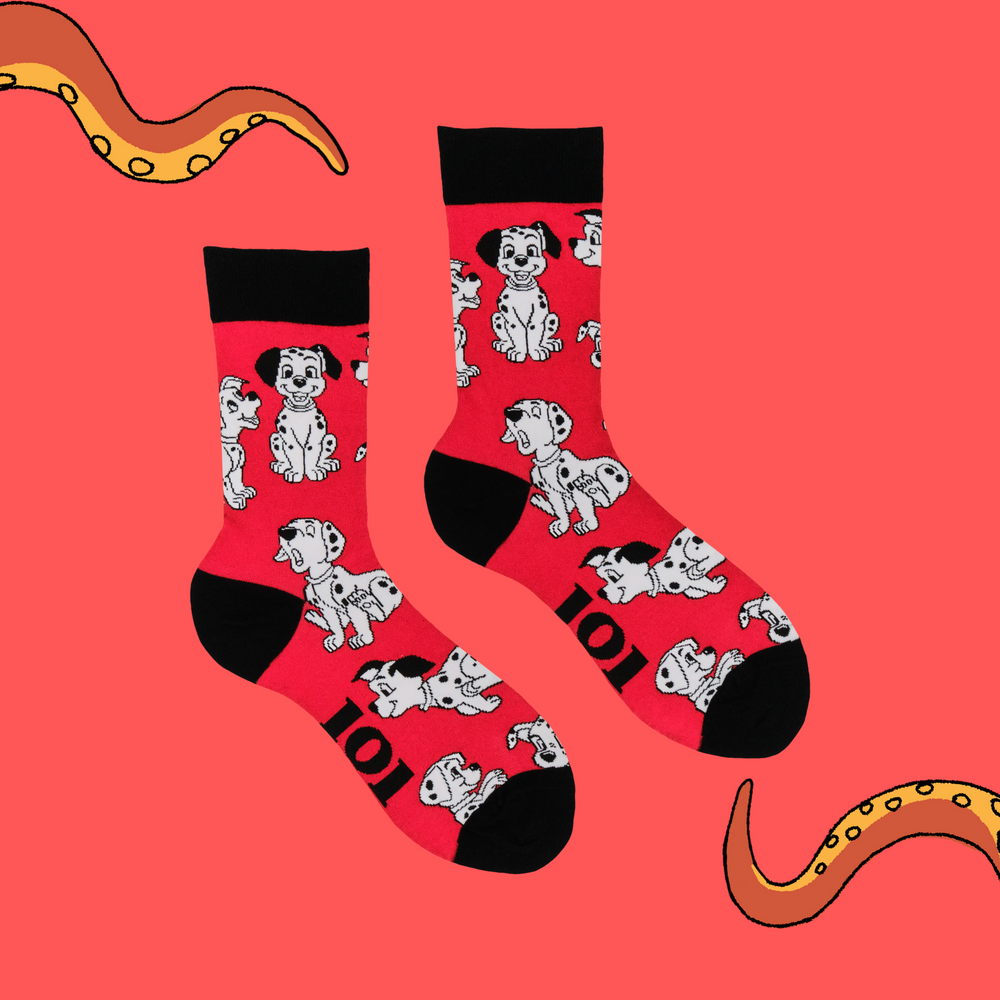 
                      
                        A pair of socks featuring characters from the 1961 disney hit, 101 dalmatians. Red legs, black toe, heel and cuff. 
                      
                    