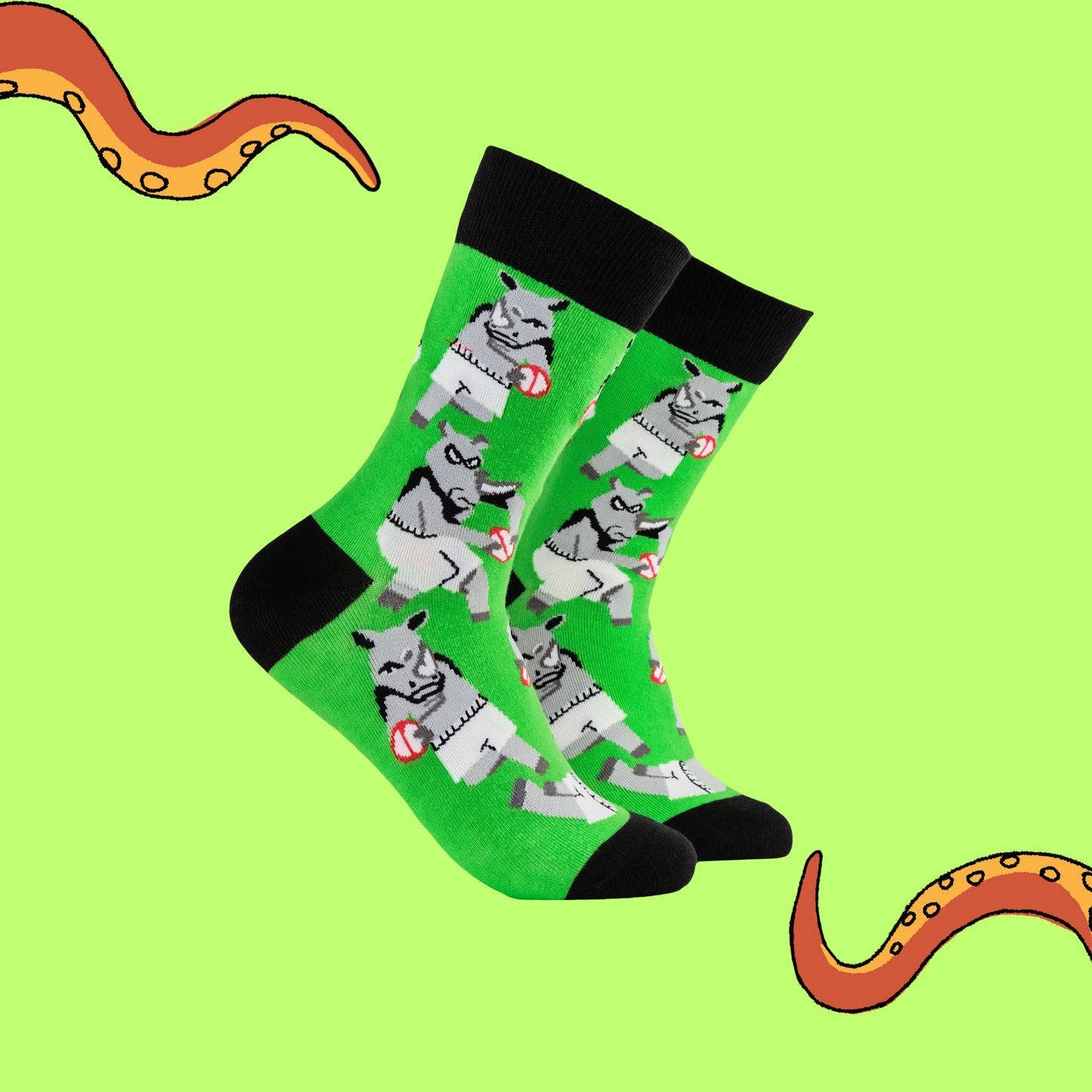 A pair of socks featuring rhinos playing rugby. Green legs, black heel, toe and cuff. 