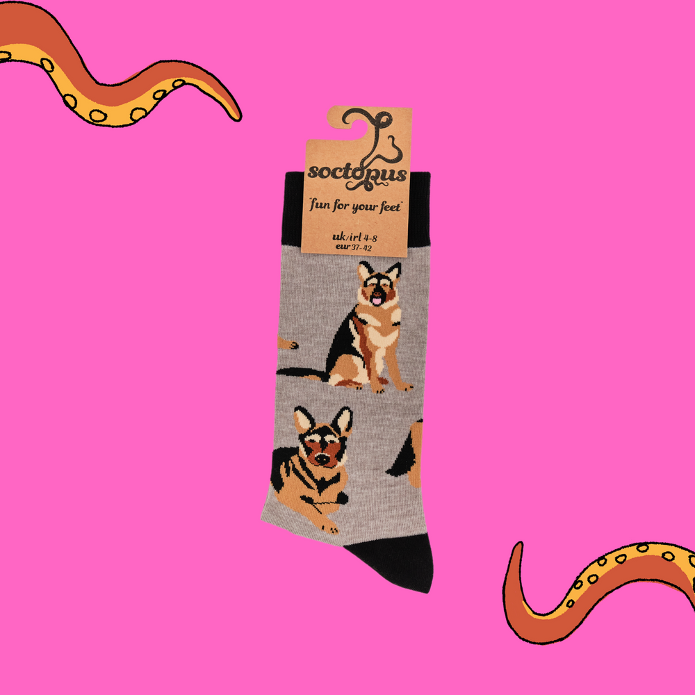 
                  
                    A pair of socks depicting German Shepherd dogs. Grey legs, black cuff, heel and toe. In Soctopus Packaging.
                  
                