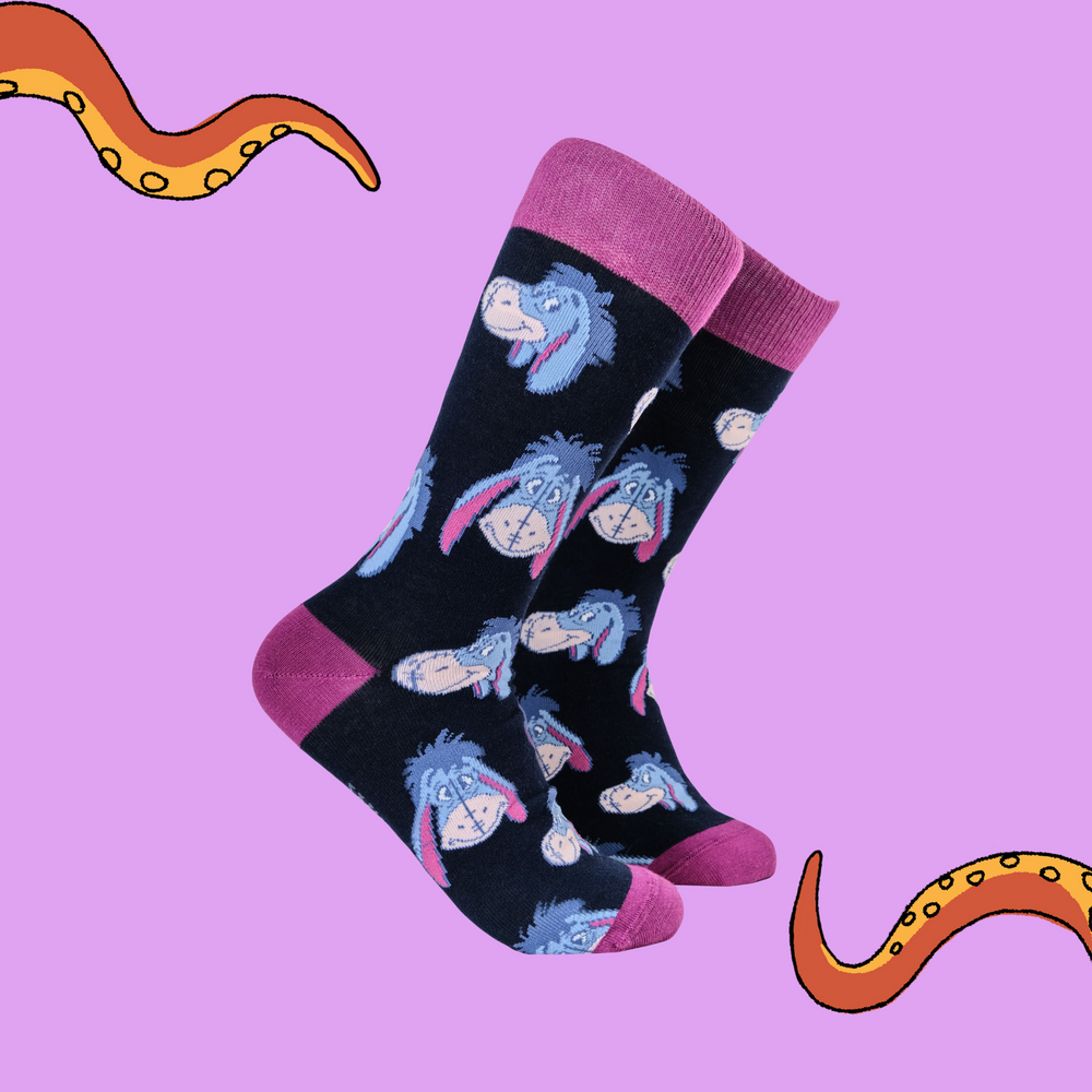 
                      
                        A pair of socks depicting eeyore. Black legs, pink heel, toe and cuff. 
                      
                    