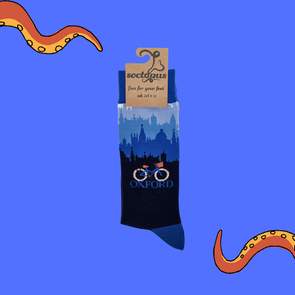 
                  
                    A pair of socks depicting the Oxford skyline and a traditional bicycle. Blue legs, blue cuff, heel and toe. In Soctopus Packaging.
                  
                