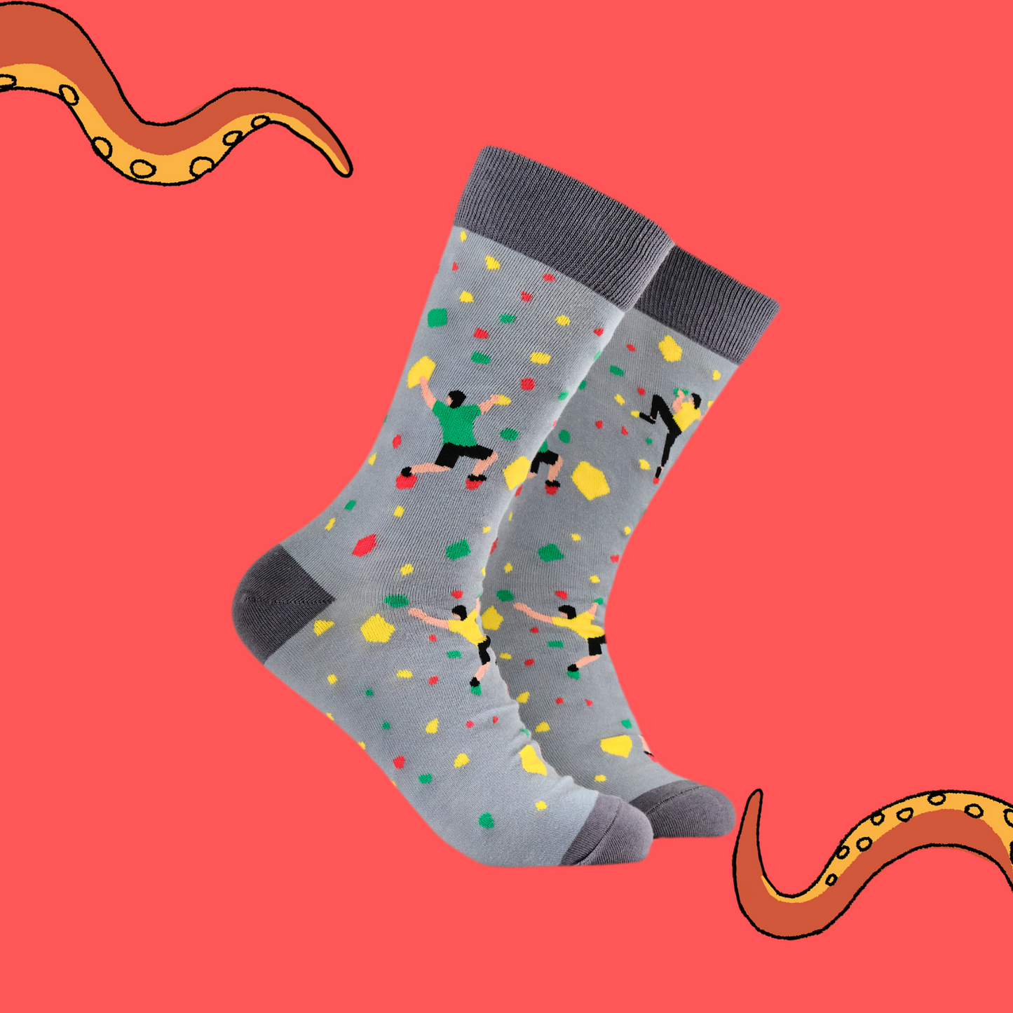 A pair of socks with a rock climbing motif. Grey legs, dark grey heel, toe and cuff. 