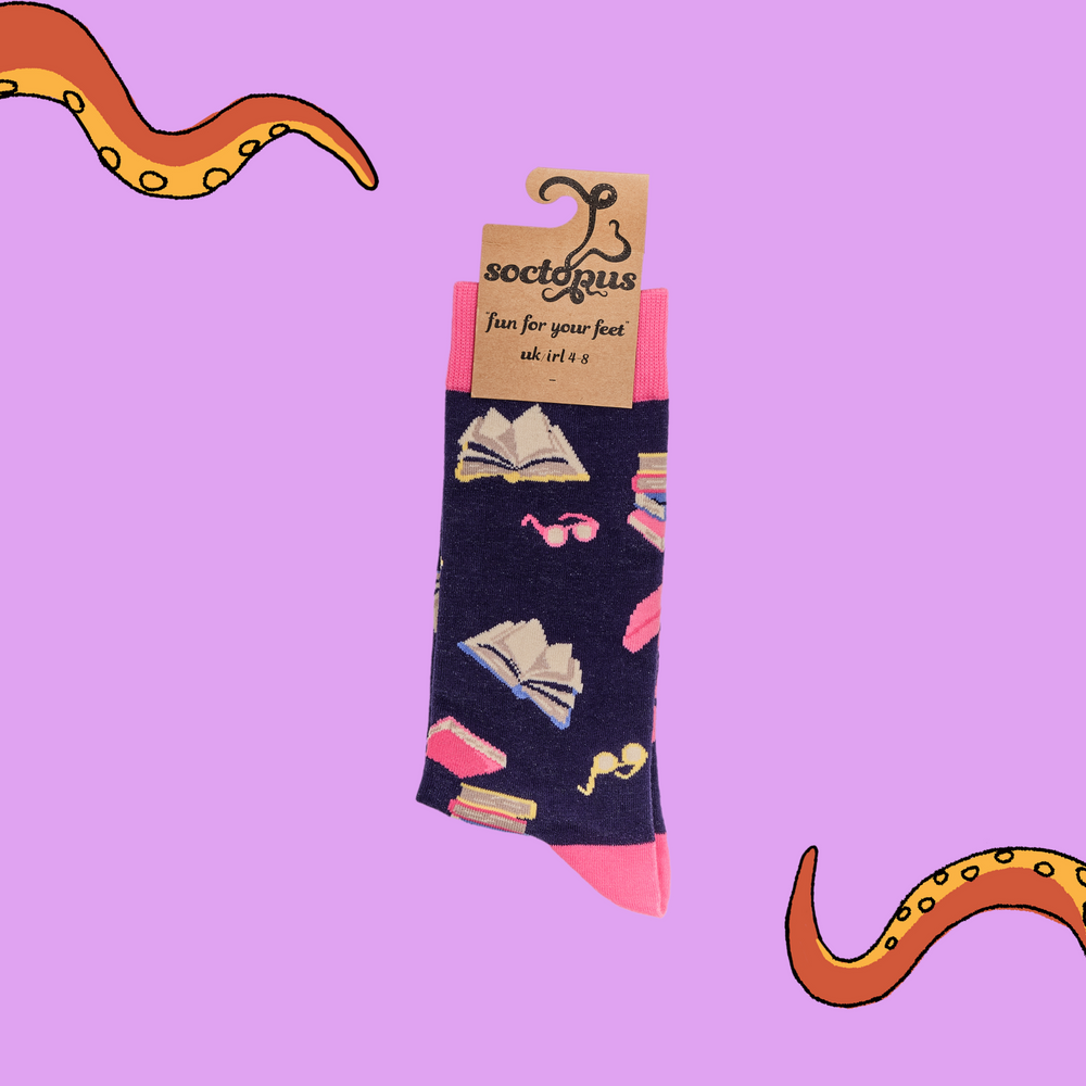 
                  
                    A pair of socks depicting books and reading glasses. Purple legs, pink cuff, heel and toe.
                  
                