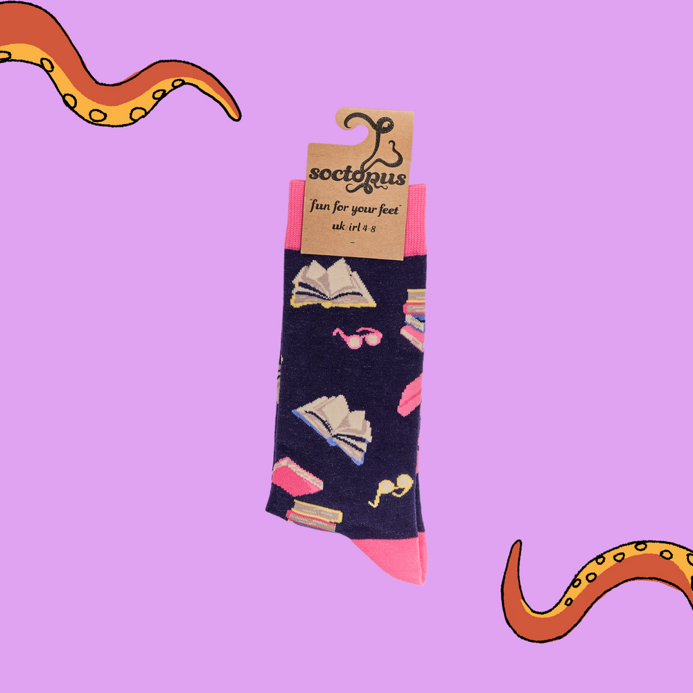 
                      
                        A pair of socks depicting books and reading glasses. Purple legs, pink cuff, heel and toe.
                      
                    