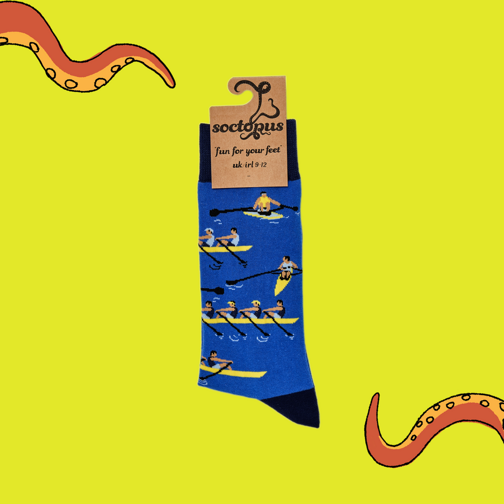 
                  
                    A pair of socks depicting row boat racers. Blue legs, dark blue cuff, heel and toe. In Soctopus Packaging.
                  
                