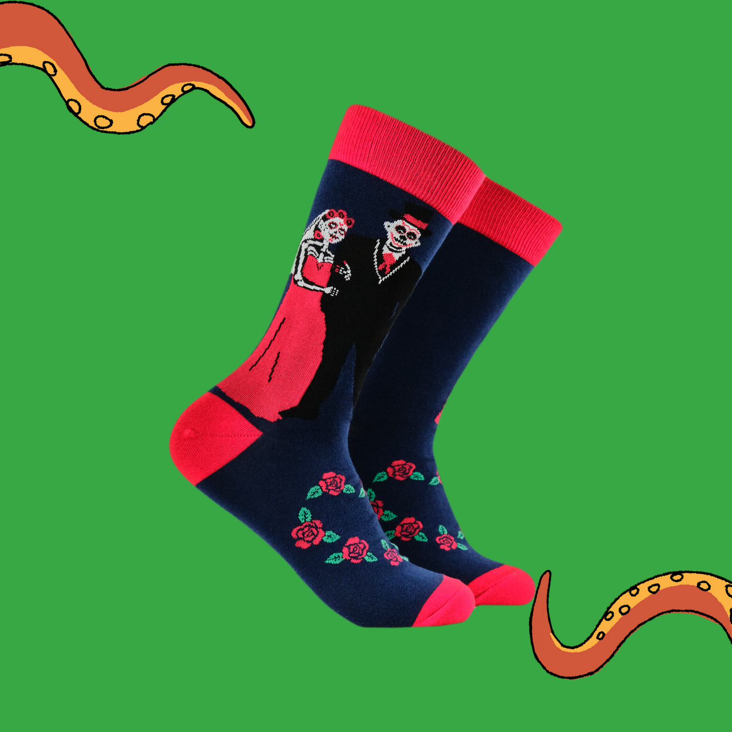 A pair of socks with a day of the dead motif. Dark blue legs, red heel, toe and cuff. 