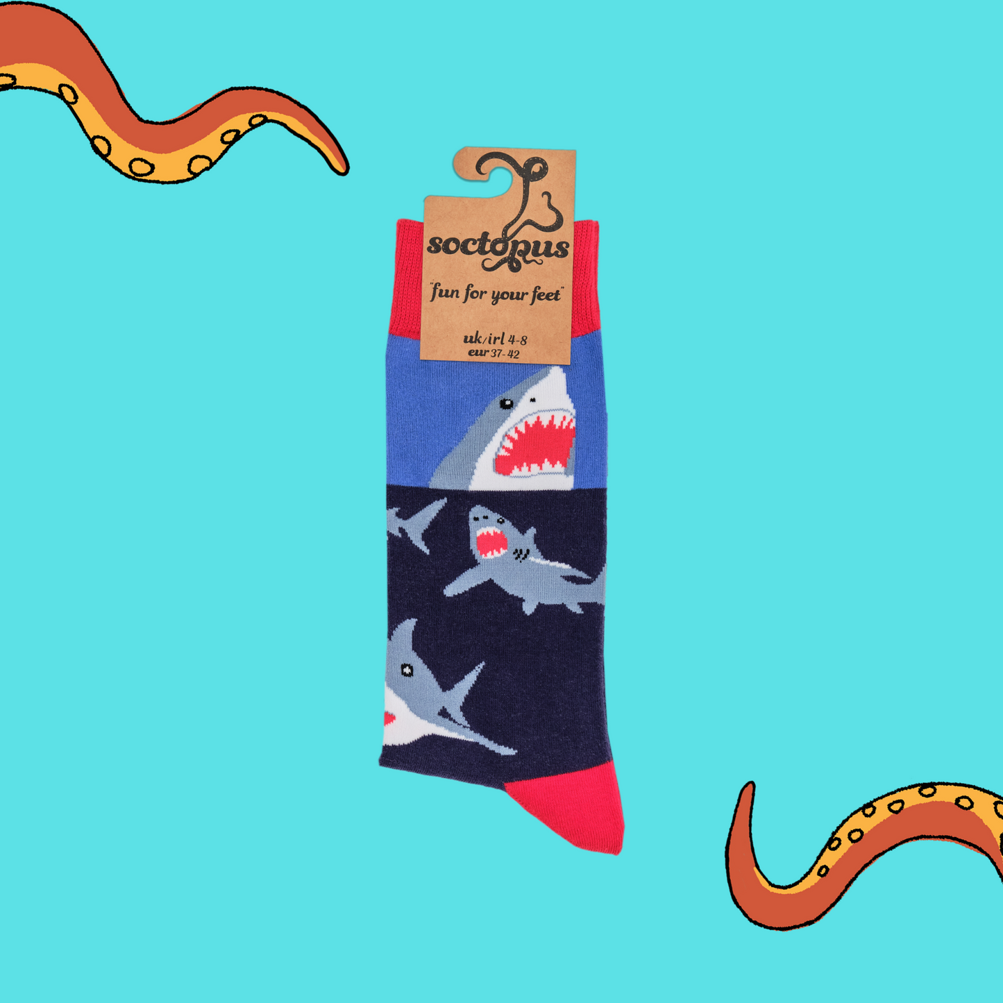 
                  
                    A pair of socks depicting great white sharks. Blue legs, red cuff, heel and toe. In Soctopus Packaging.
                  
                