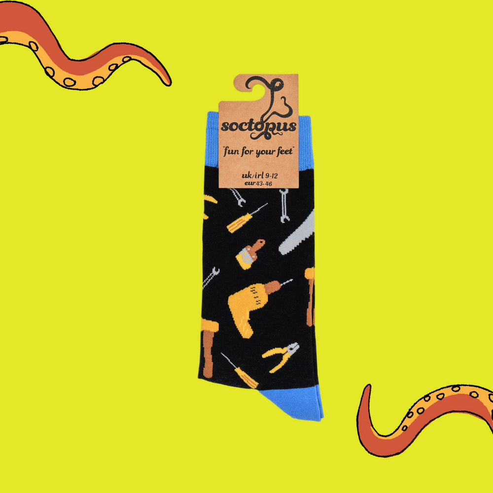 
                      
                        A pair of socks depicting DIY tools. Black legs, blue cuff, heel and toe. In Soctopus Packaging.
                      
                    