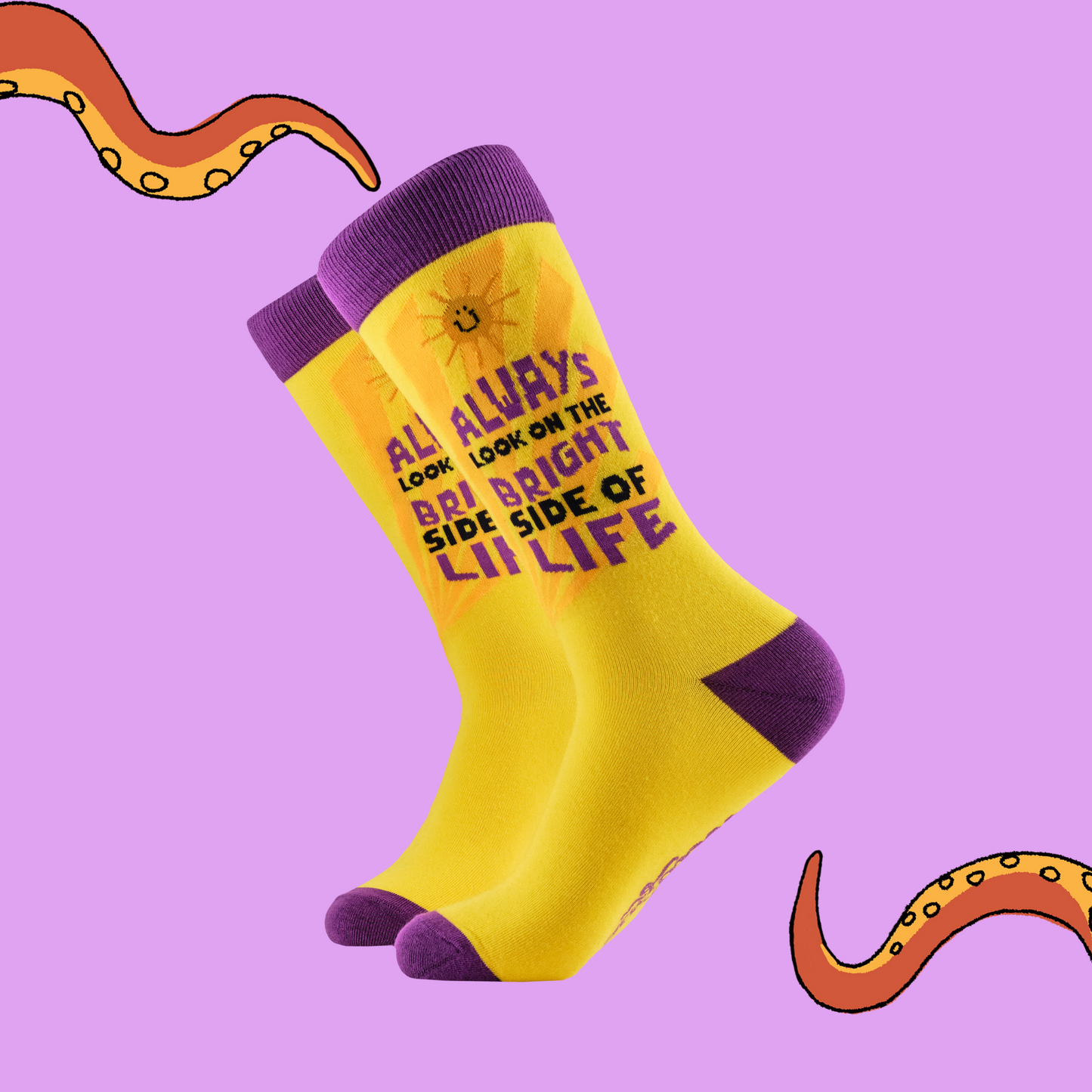 A pair of socks with the slogan 'Always look on the bright side of life'. Bright yellow legs, purple toe, cuff and heel. 