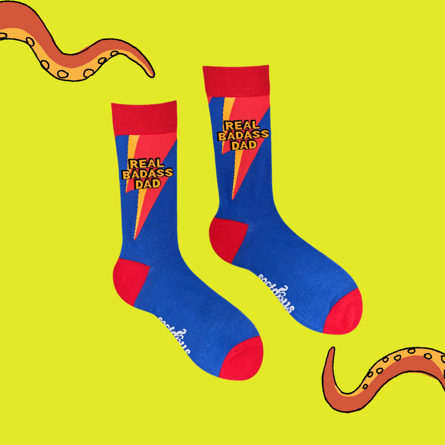 
                  
                    A pair of socks depicting the words Real Badass Dad. Blue legs, red cuff, heel and toe.
                  
                