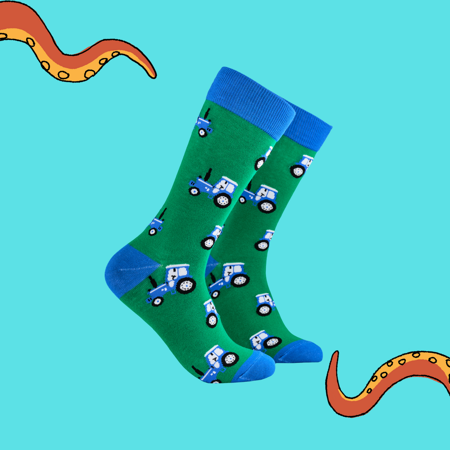 A pair of socks depicting blue tractors. Green legs, blue cuff, heel and toe.