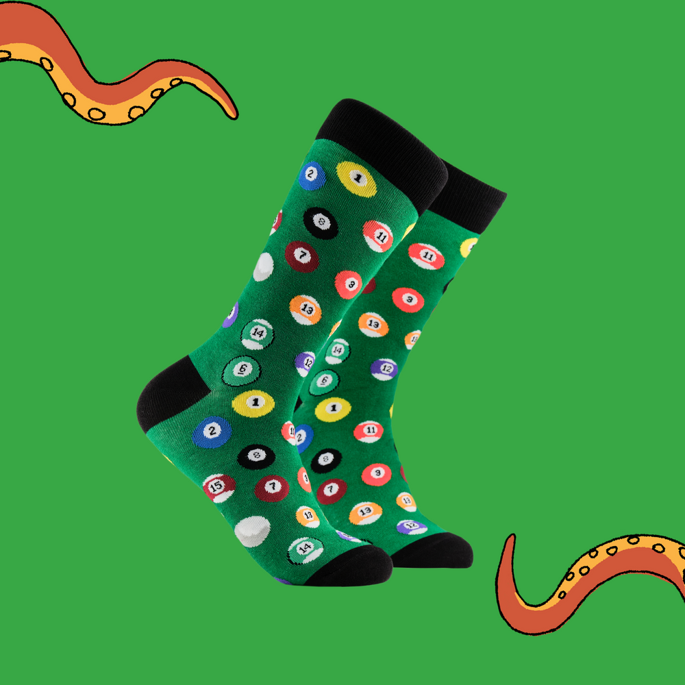 
                      
                        A pair of socks depicting pool balls. Green legs, black cuff, heel and toe.
                      
                    