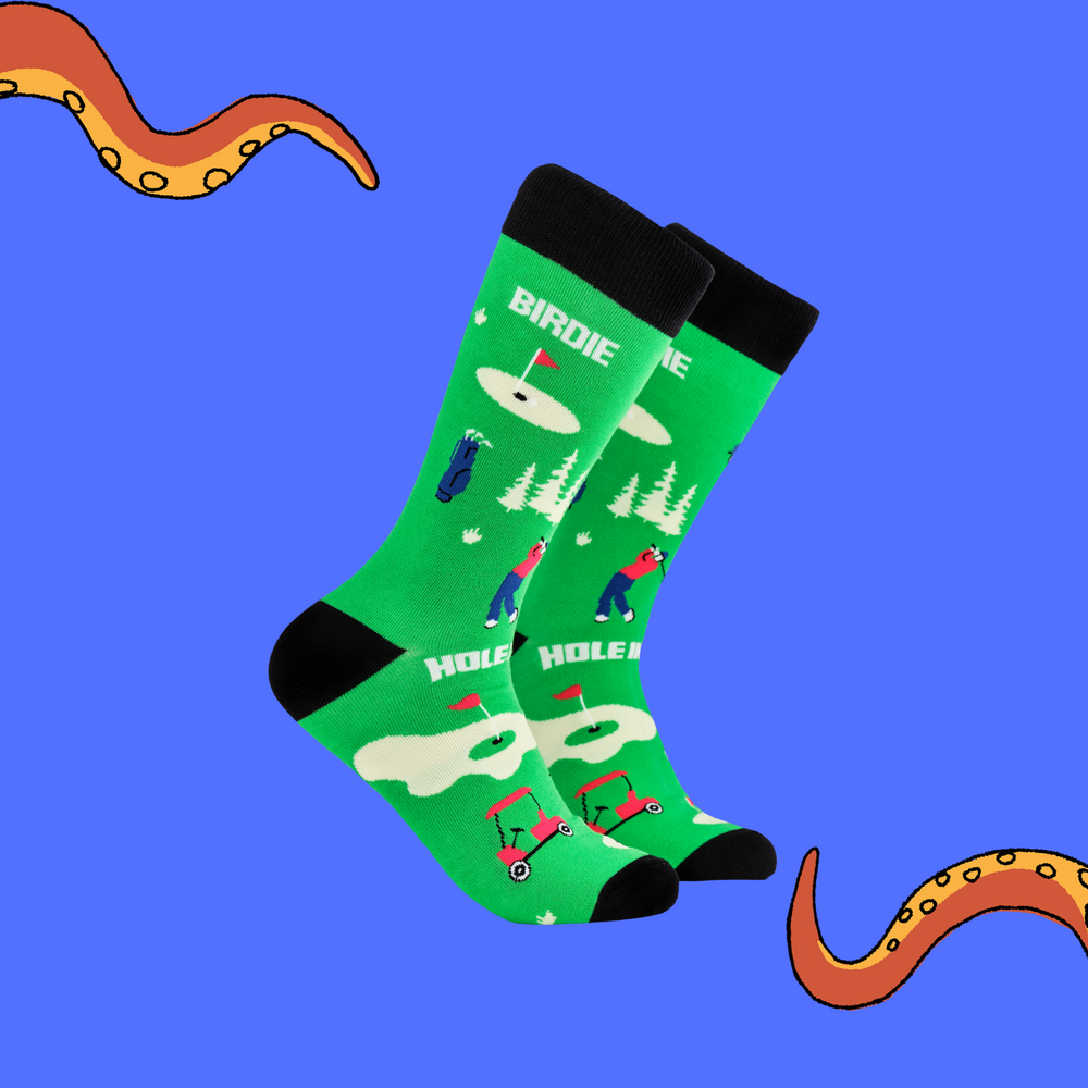 A pair of socks depicting golf. Green legs, black cuff, heel and toe.