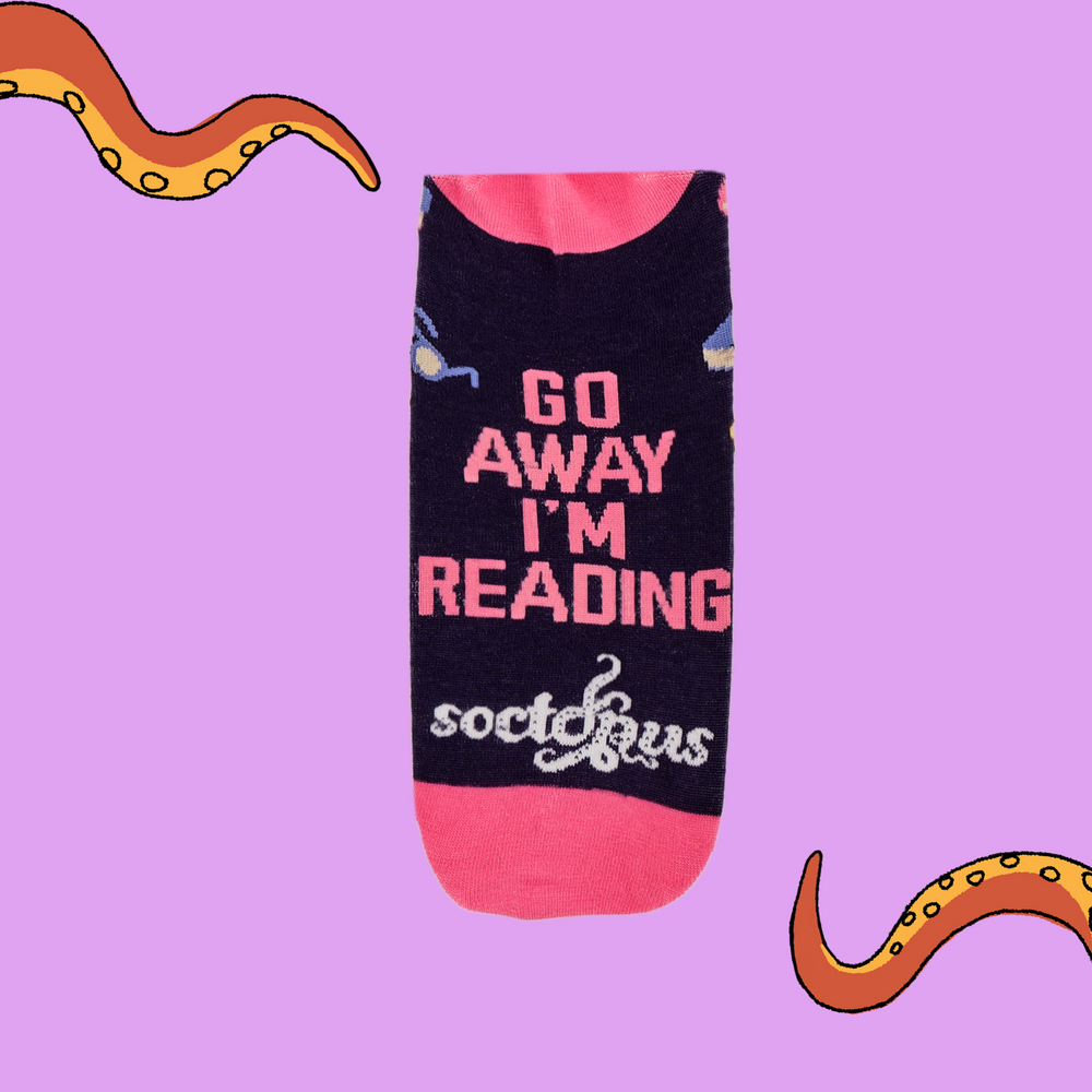 
                      
                        A pair of socks depicting books and reading glasses. Purple legs, pink cuff, heel and toe.
                      
                    