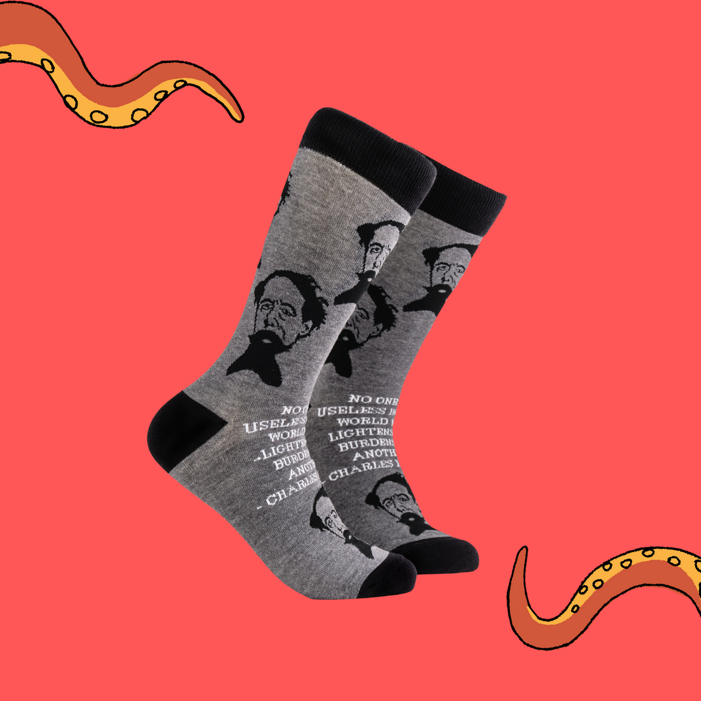 A pair of socks depicting Charles Dickens and a quote. Grey legs, black cuff, heel and toe.