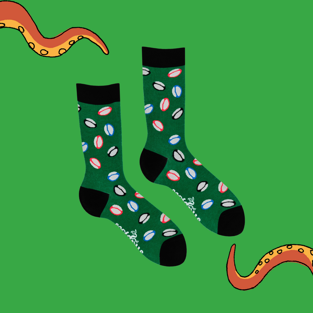 
                      
                        A pair of socks depicting rugby balls. Green legs, black cuff, heel and toe.
                      
                    