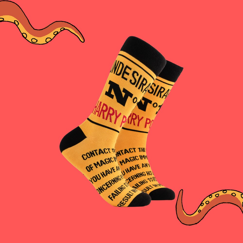 A pair of socks depicting Harry Potter Undesirable No.1. Yellow legs, black cuff, heel and toe.