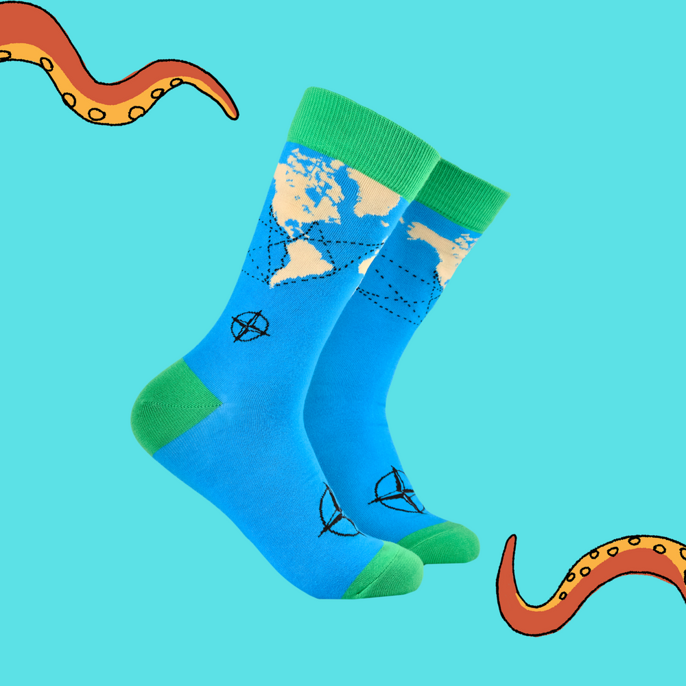 A pair of socks featuring a world map and compass. Bright blue legs, green heel, toe and cuff. 