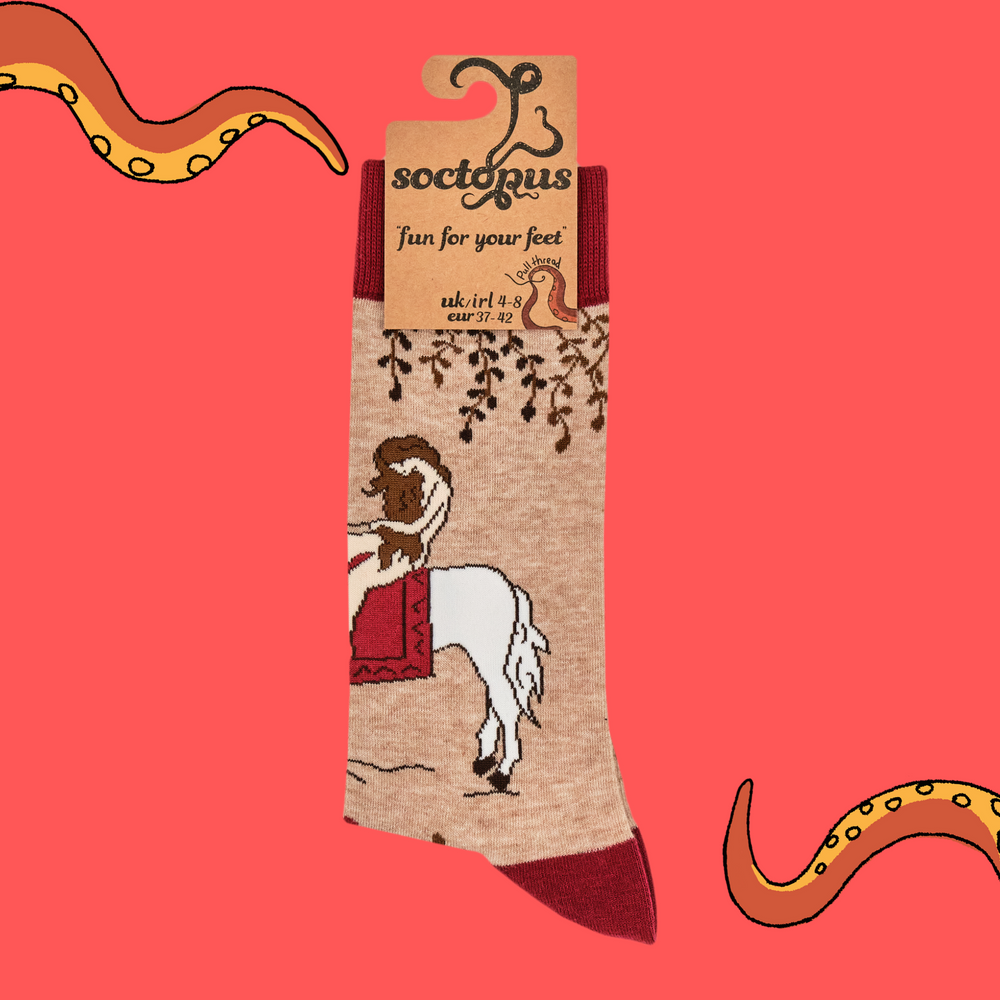 
                      
                        A pair of socks featuring Lady Godiva. Beige legs, red heel, toe and cuff. 
                      
                    