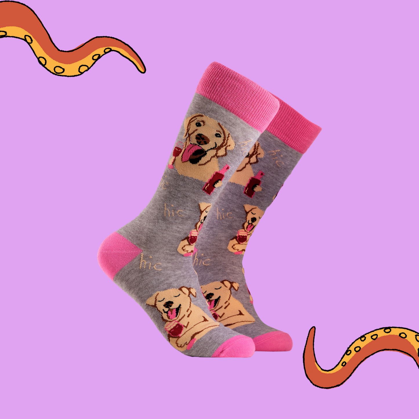 A pair of socks depicting labs drinking wine. Grey legs, light pink cuff, heel and toe.