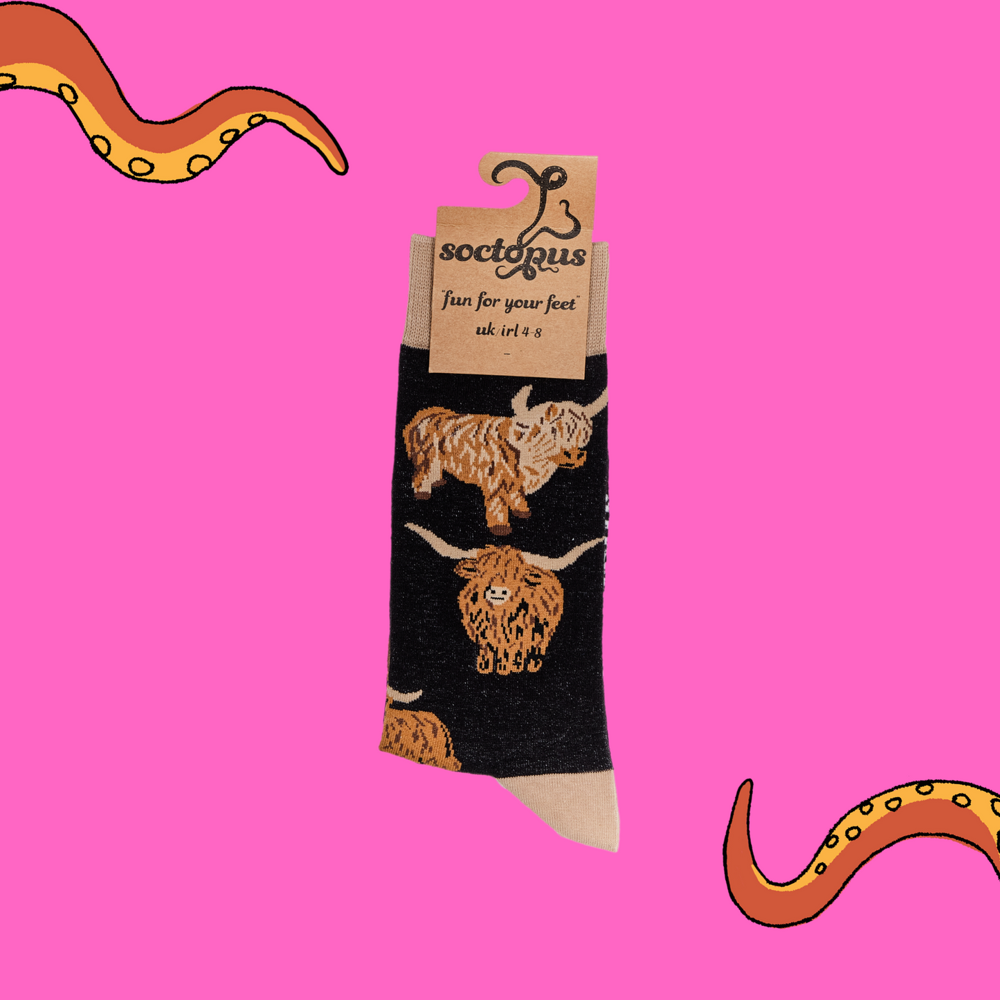 
                  
                    A pair of socks depicting highland cows. Black legs, cream cuff, heel and toe. In Soctopus Packaging.
                  
                