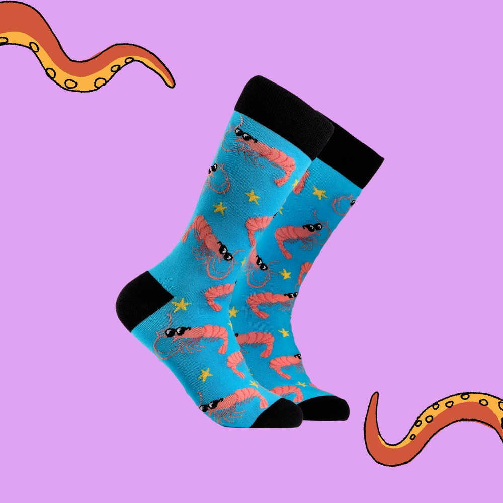 A pair of socks depicting cool prawns in sunglasses. Bright blue legs, black cuff, heel and toe.