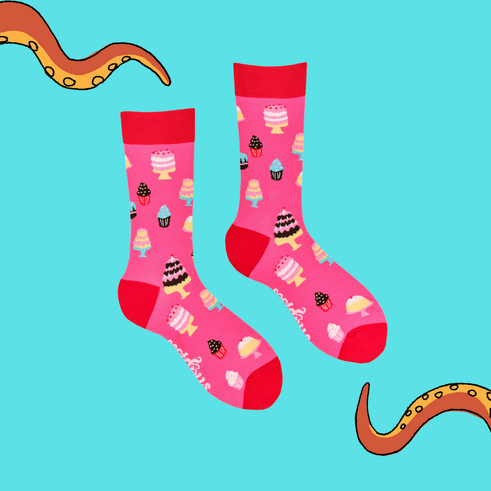 
                      
                        A pair of socks depicting cakes. Pink legs, red cuff, heel and toe.
                      
                    