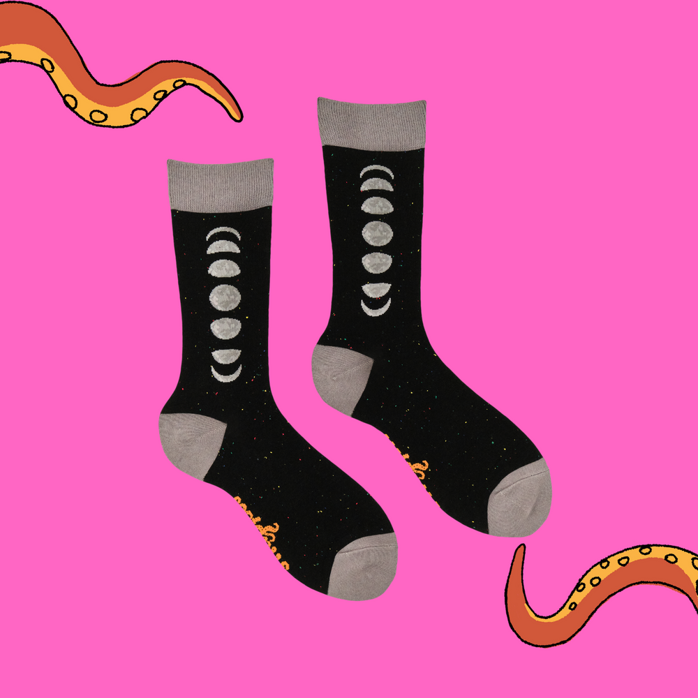 
                      
                        A pair of socks featuring the phases of the moon. Black legs, grey heel, toe and cuff. 
                      
                    