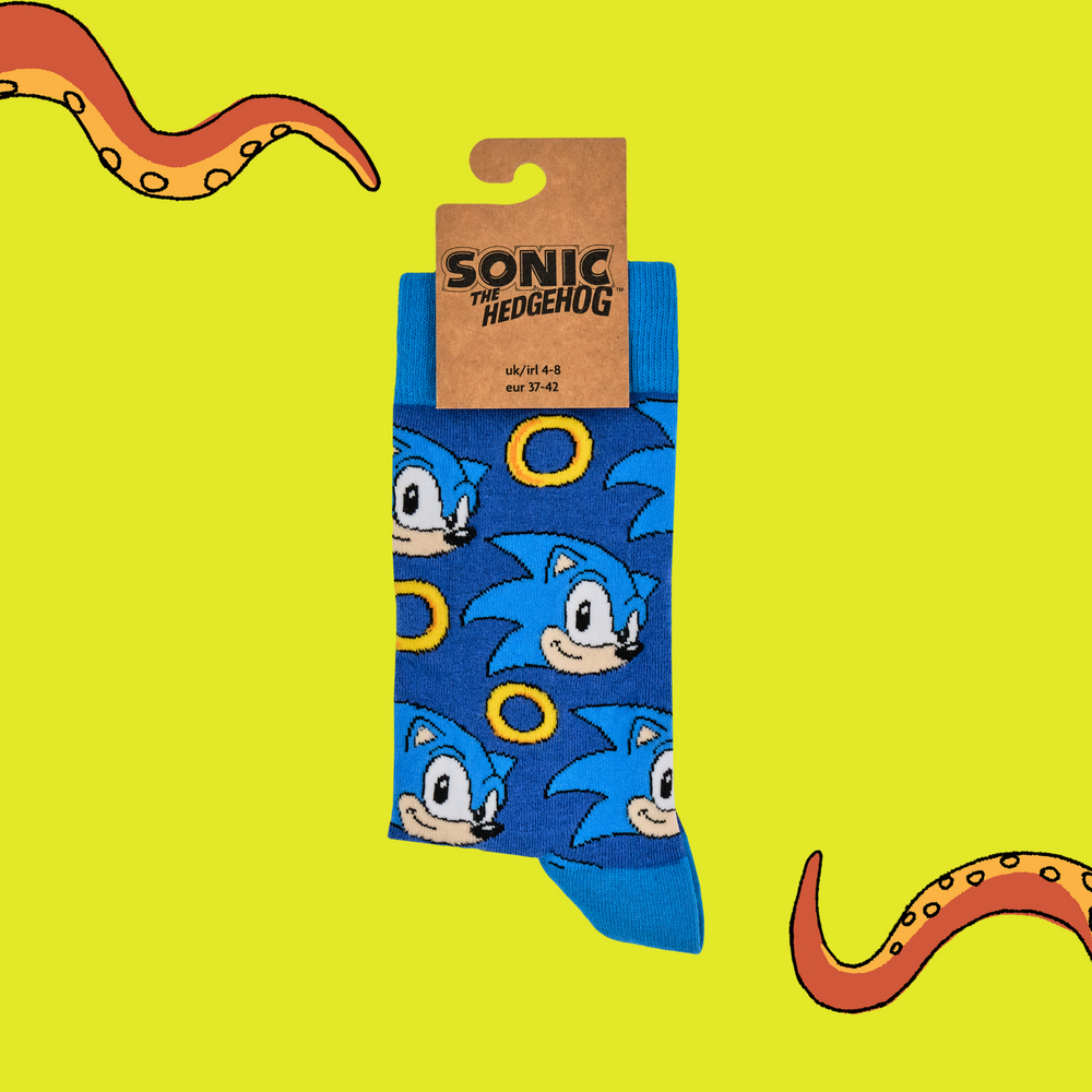 
                      
                        A pair of socks featuring Sonic with power rings. Dark blue legs, light blue heel, cuff and toe. 
                      
                    