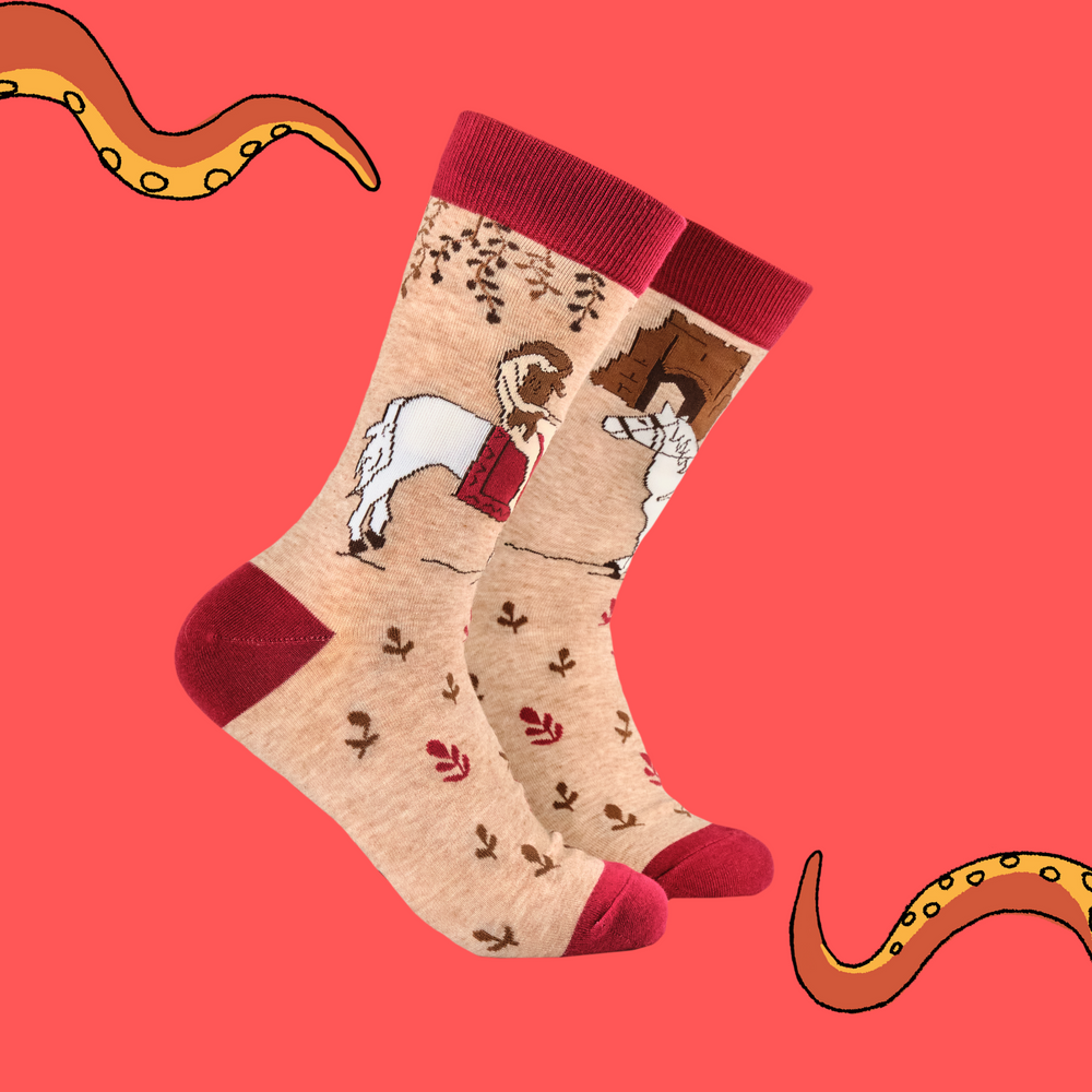 A pair of socks featuring Lady Godiva. Beige legs, red heel, toe and cuff. 