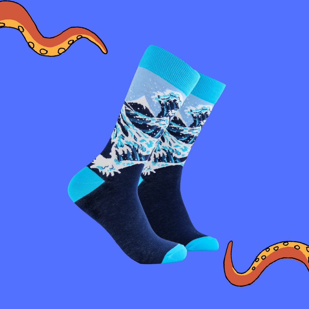 A pair of socks depicting The Great Wave off Kanagawa. Dark blue legs, bright blue cuff, heel and toe.