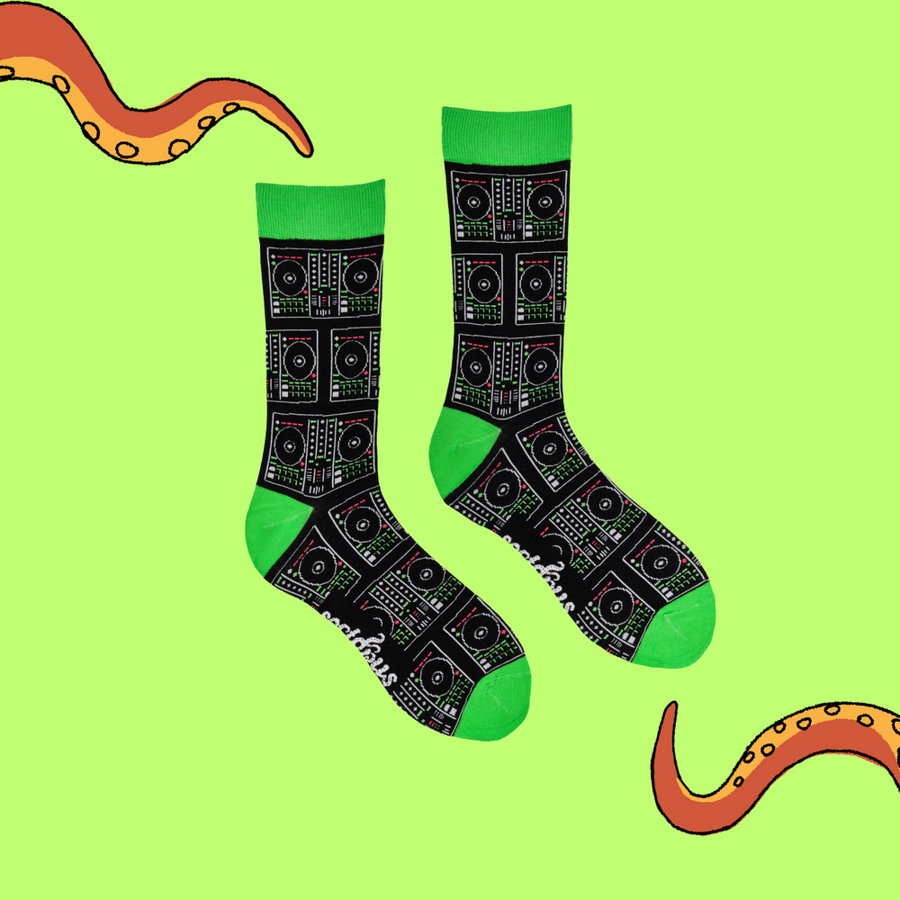 
                  
                    A pair of socks depicting digital DJ controllers. Black legs, green cuff, heel and toe.
                  
                