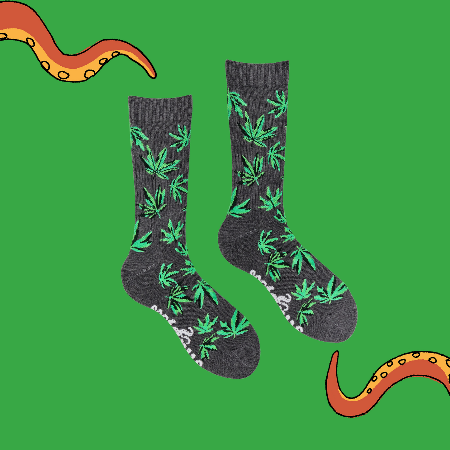 
                  
                    A pair of socks depicting cannabis leaves. Grey athletic legs, grey cuff, heel and toe.
                  
                