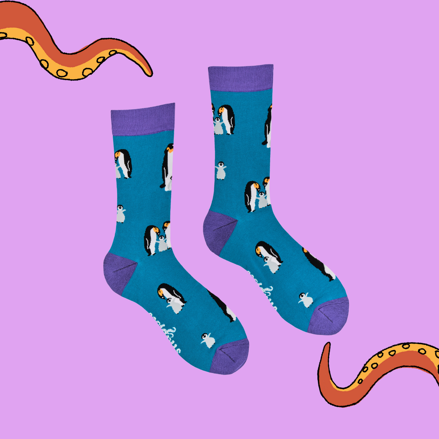 
                  
                    A pair of socks depicting a penguin family. Blue legs, purple cuff, heel and toe.
                  
                