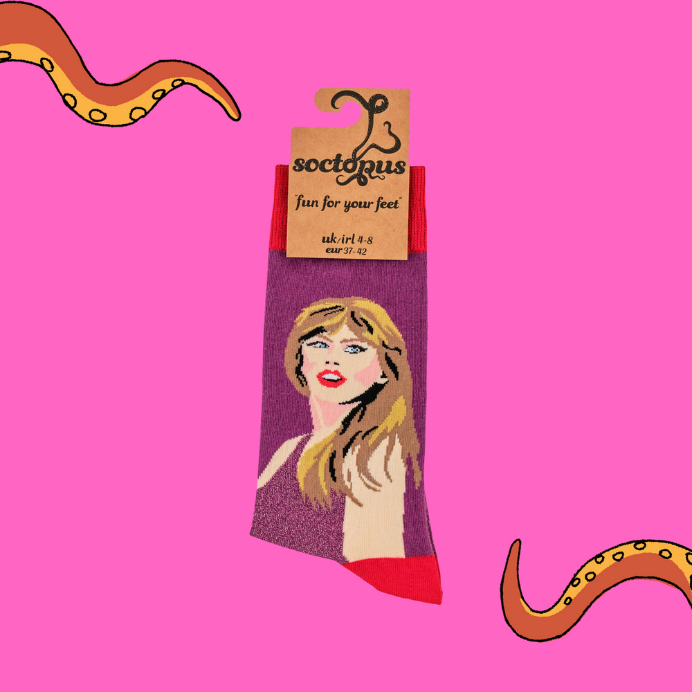 
                      
                        A pair of socks featuring Taylor Swift. Pink glittery legs, red heel toe and cuff. 
                      
                    