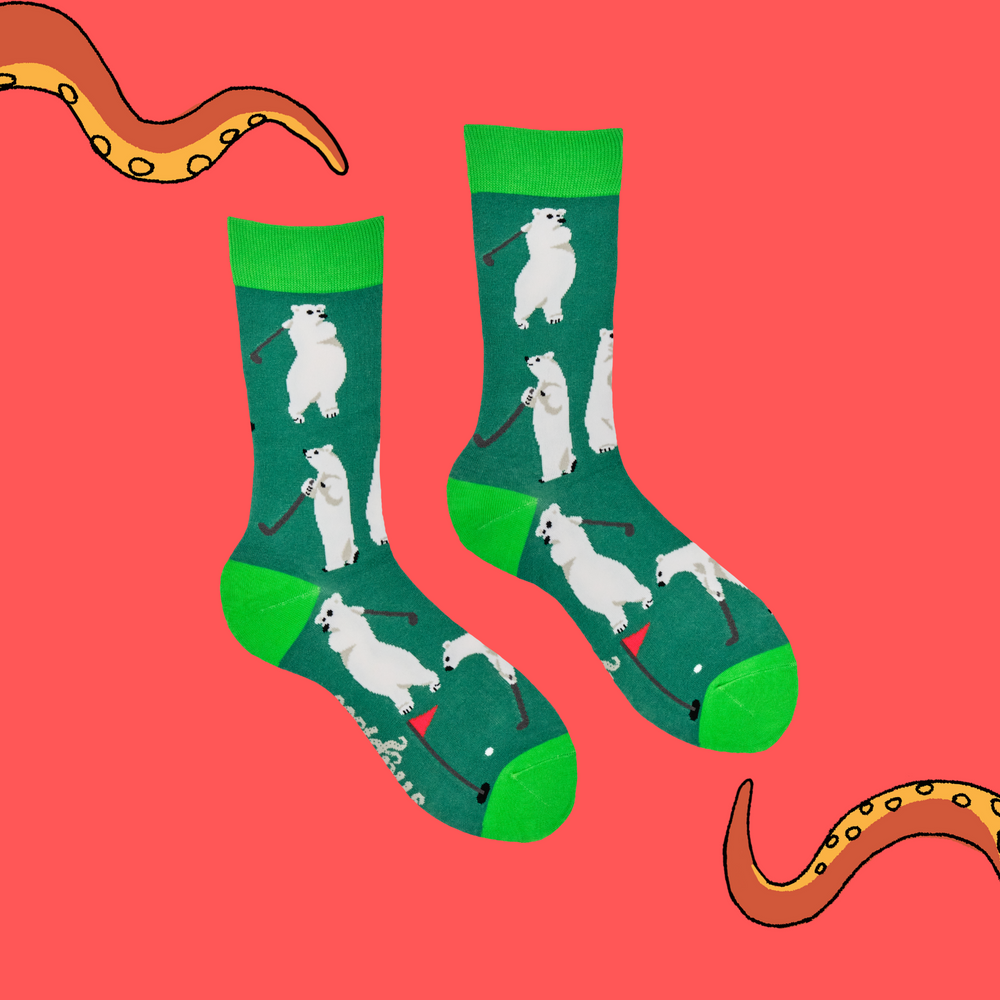 
                      
                        A pair of socks depicting a polar bear playing golf. Dark green legs, bright green heel, toe and cuff. 
                      
                    