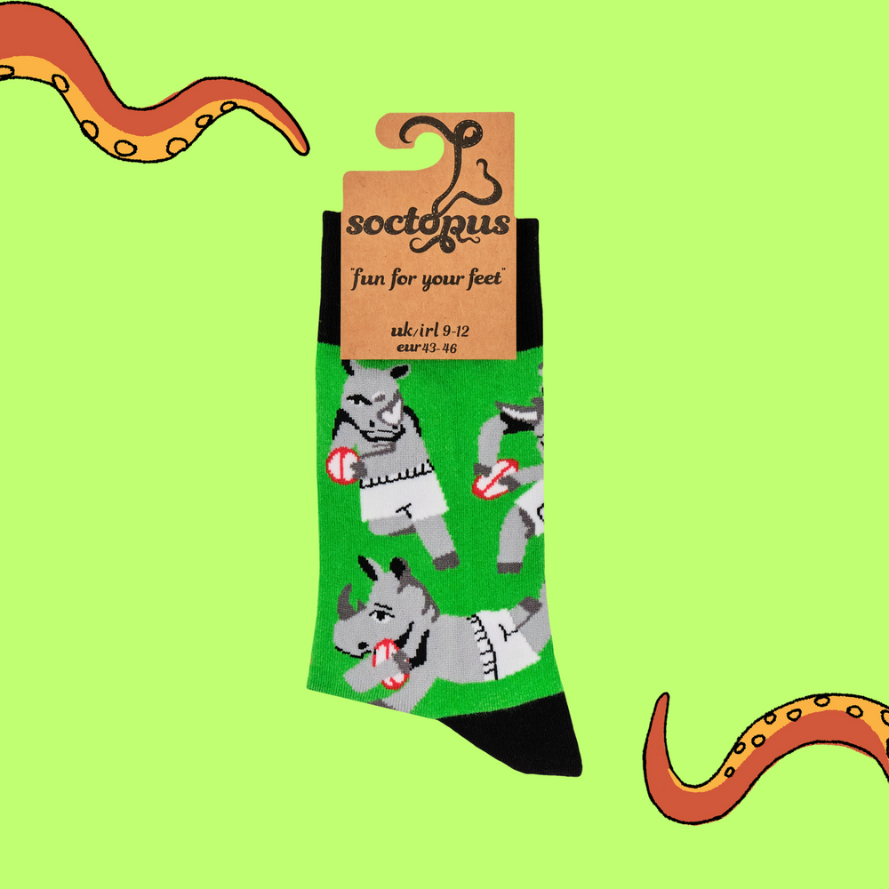 
                      
                        A pair of socks featuring rhinos playing rugby. Green legs, black heel, toe and cuff. 
                      
                    