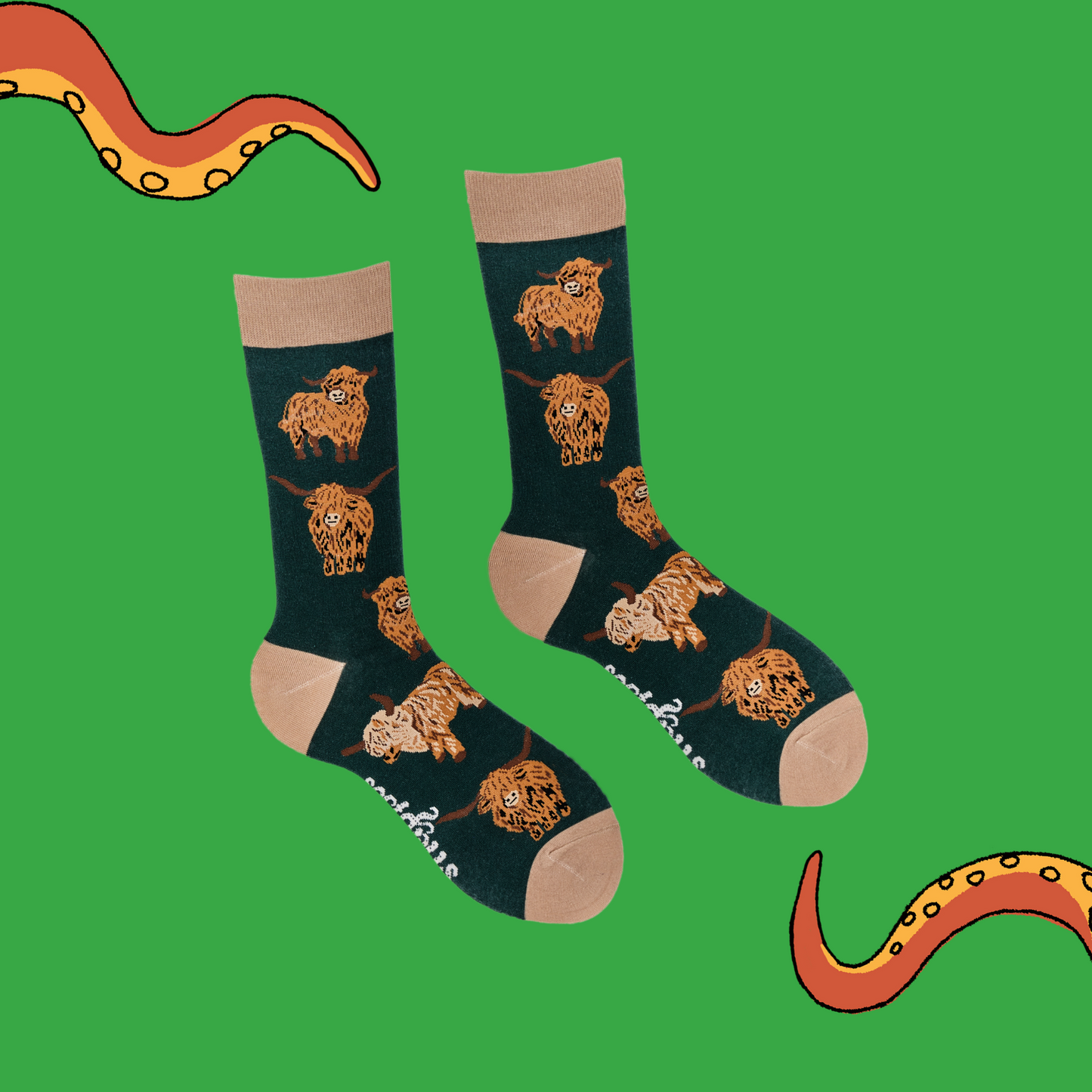 
                  
                    A pair of socks depicting highland cows. Dark green legs, cream cuff, heel and toe.
                  
                