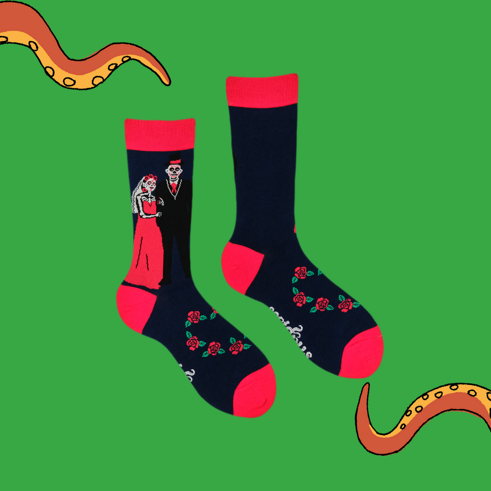 
                      
                        A pair of socks with a day of the dead motif. Dark blue legs, red heel, toe and cuff. 
                      
                    