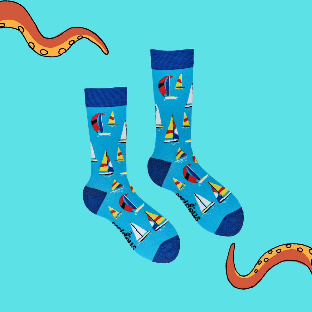 
                      
                        A pair of socks depicting sailing boats. Blue legs, dark cuff, heel and toe.
                      
                    