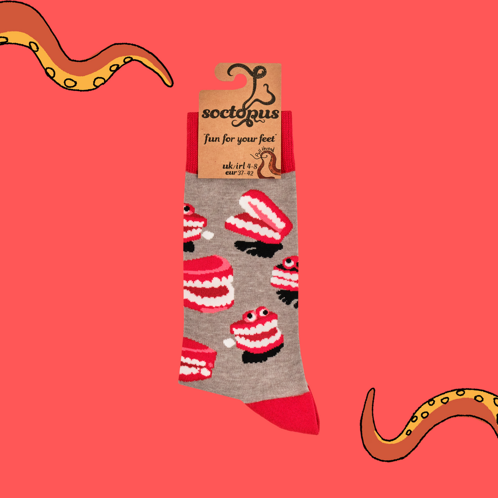 
                      
                        A pair of socks featuring wind up teeth. Brown legs, red heel, toe and cuff. 
                      
                    