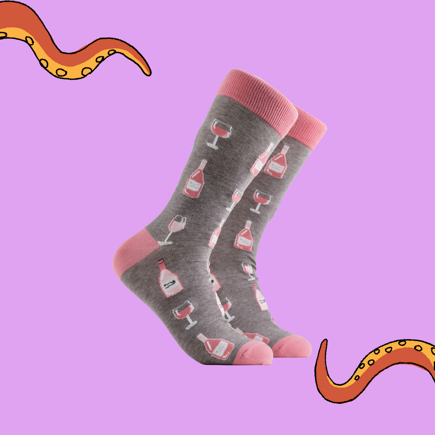 A pair of socks depicting Rose wine bottles and glasses. Grey legs, pink cuff, heel and toe.