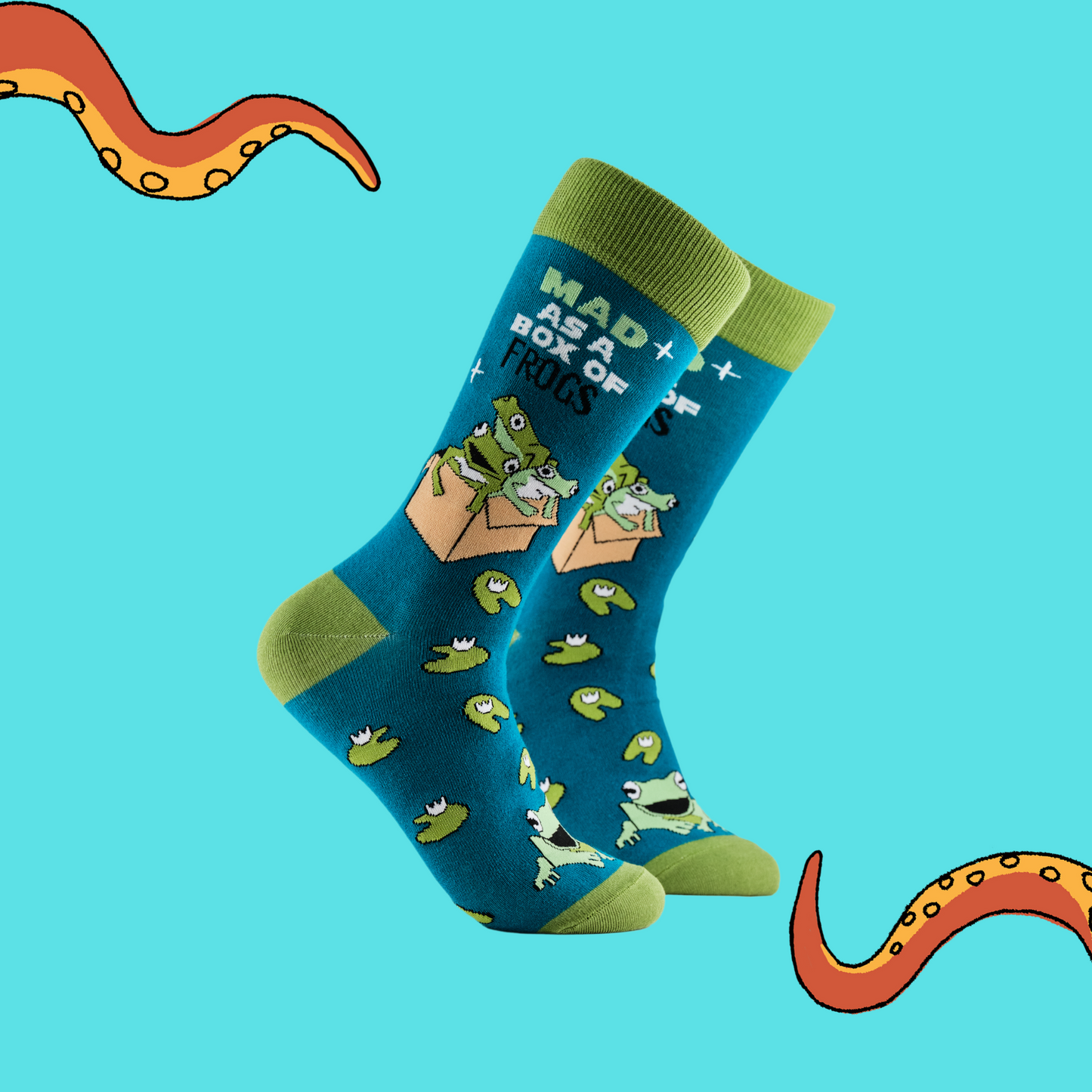 A pair of socks depicting a box of mad frogs. Blue legs, green cuff, heel and toe.